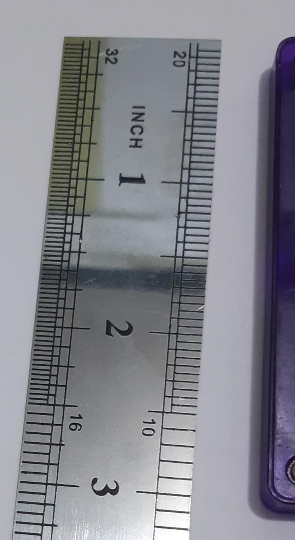 picture of magna-tile next to ruler showing its length along the base